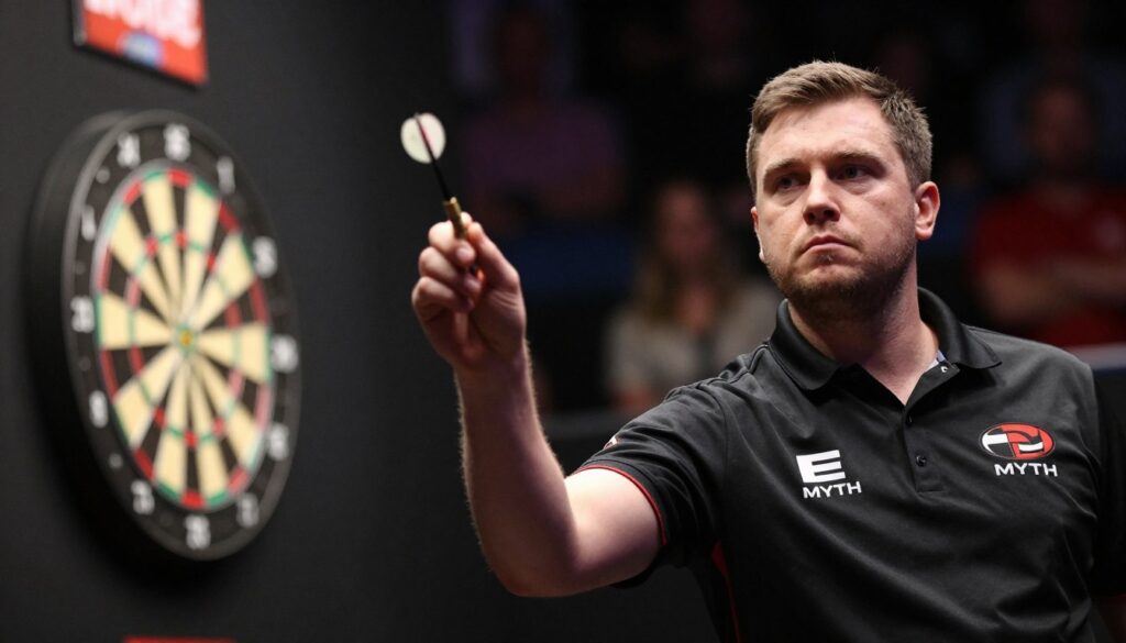 A professional darts player in a focused stance, preparing to throw, captured in a dimly lit, intense atmosphere filled with concentration. The foreground features the player's hand gripping a dart with precision, showing excellent technique and focus. In the middle, a blurred dartboard is visible, highlighting the player’s target. The background includes subtle hints of the crowd and professional lighting focused on the player, creating an ambient glow that emphasizes the mental intensity required in the game. The mood is serious and contemplative, conveying the mental focus and discipline of competitive darts players, branded with "E MYTH". Use a shallow depth of field and a slightly upward angle to enhance the player's determined expression.